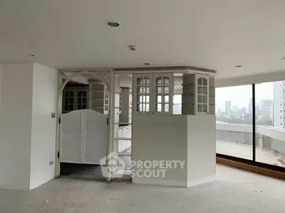 Spacious open-plan living area with city view and unique interior design.