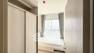 Bright and airy bedroom with large window and modern furnishings