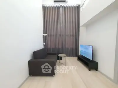 Modern living room with sleek furniture and large window curtains