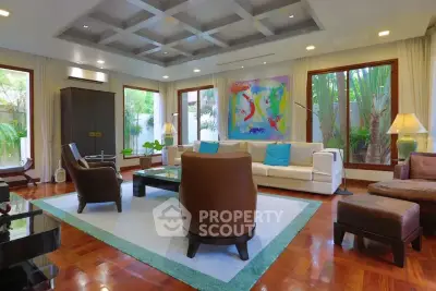 Luxurious living room with modern decor, large windows, and elegant furniture in a spacious home.
