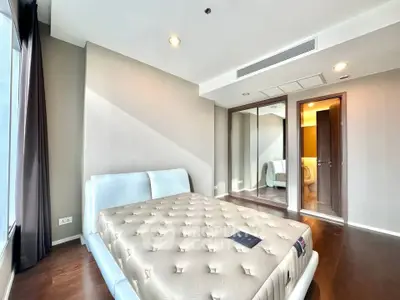 Spacious bedroom with modern design and large windows for natural light.