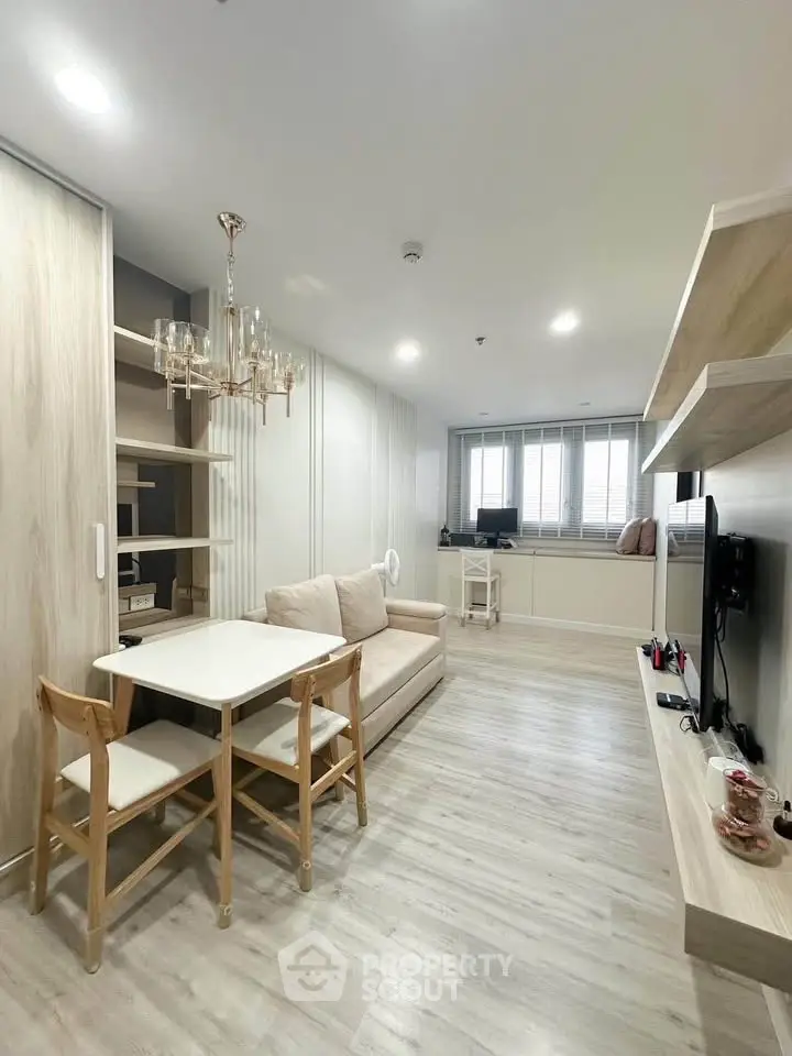 Modern living room with elegant chandelier and cozy seating area