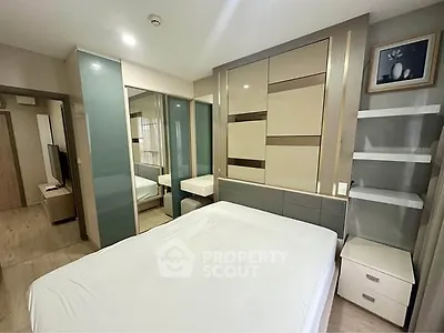 Modern bedroom with sleek design and ample storage in a stylish apartment.