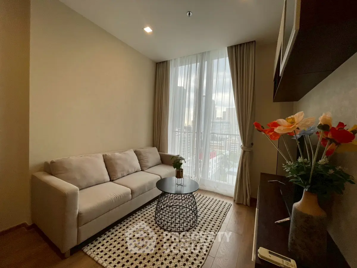 Cozy living room with modern decor and city view, featuring a comfortable sofa and stylish coffee table.