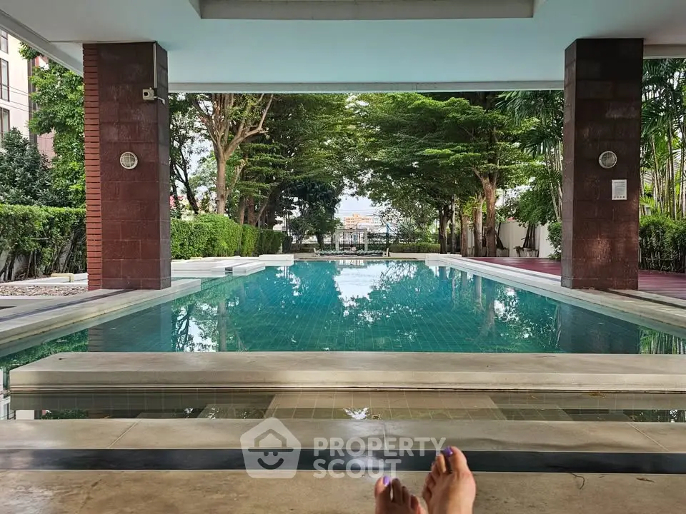 Luxurious poolside view with lush greenery and serene ambiance