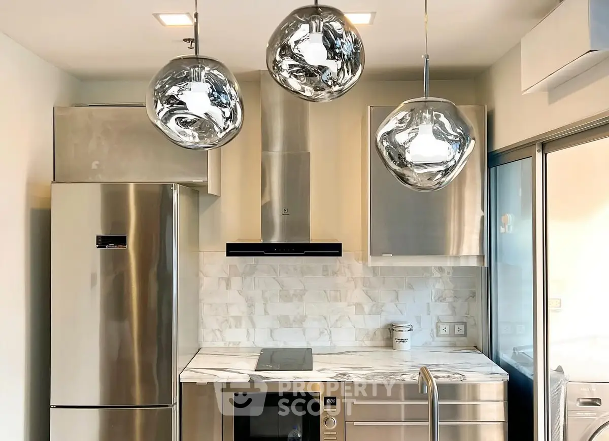 Modern kitchen with stainless steel appliances and marble backsplash