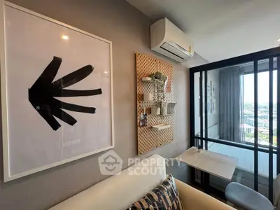 Modern living room with stylish decor and large window offering city view