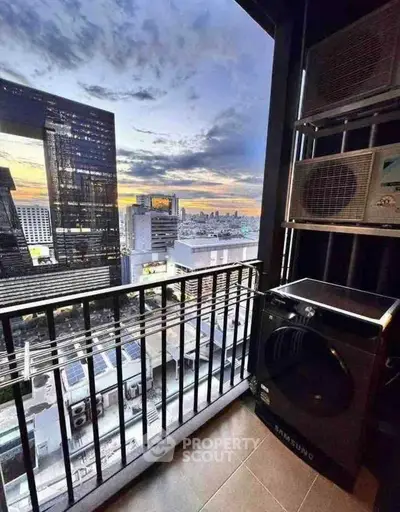 Stunning city view from a modern balcony with laundry appliances, perfect urban living.