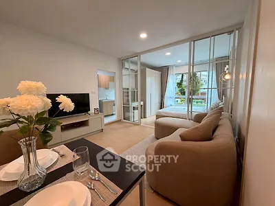 Modern open-plan living room with cozy seating and elegant dining area