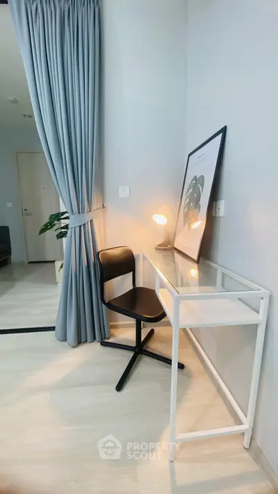 Modern study nook with sleek glass desk and stylish chair, perfect for productivity in a contemporary home.
