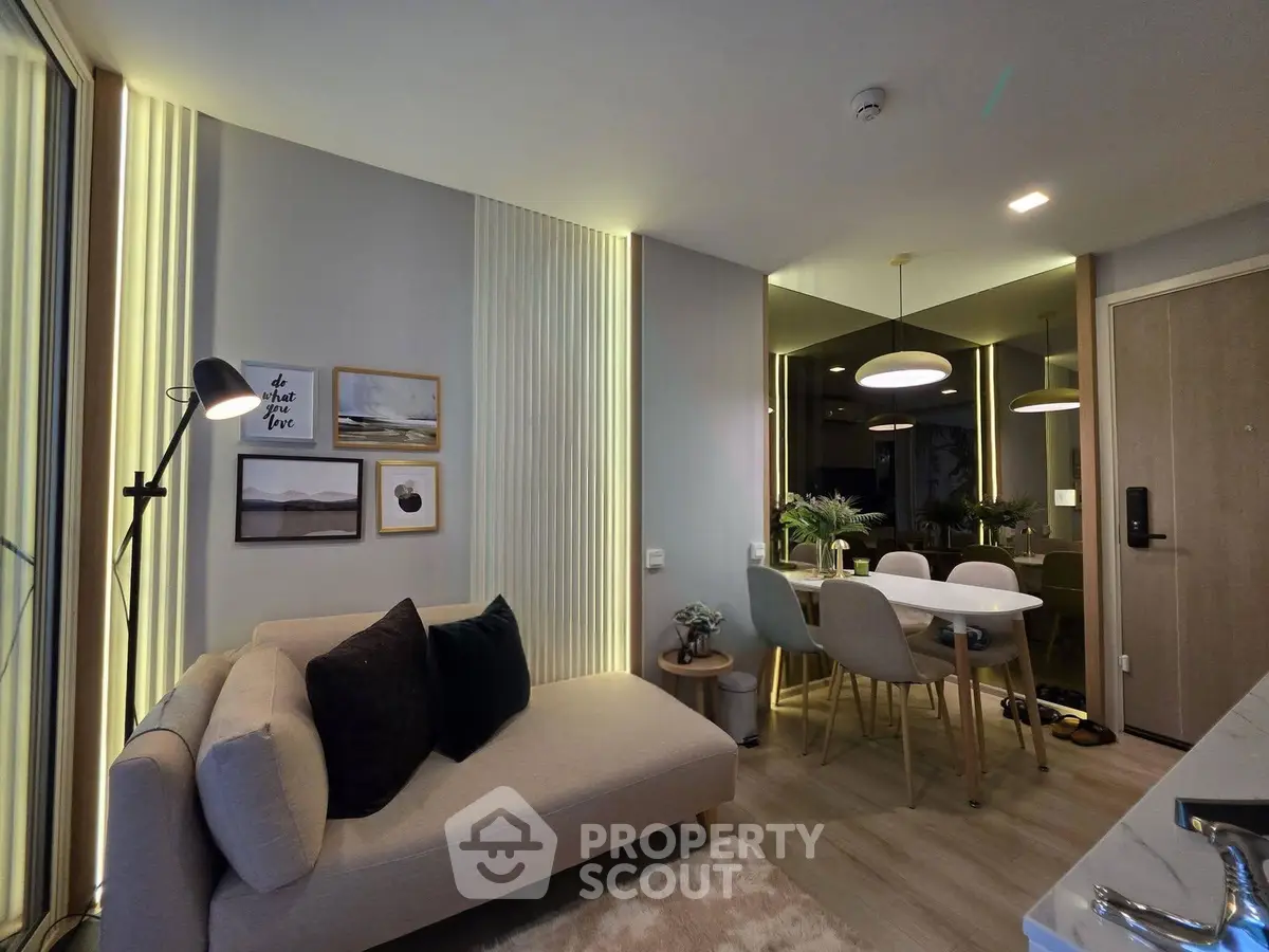 Modern living room with stylish decor and dining area in a cozy apartment.