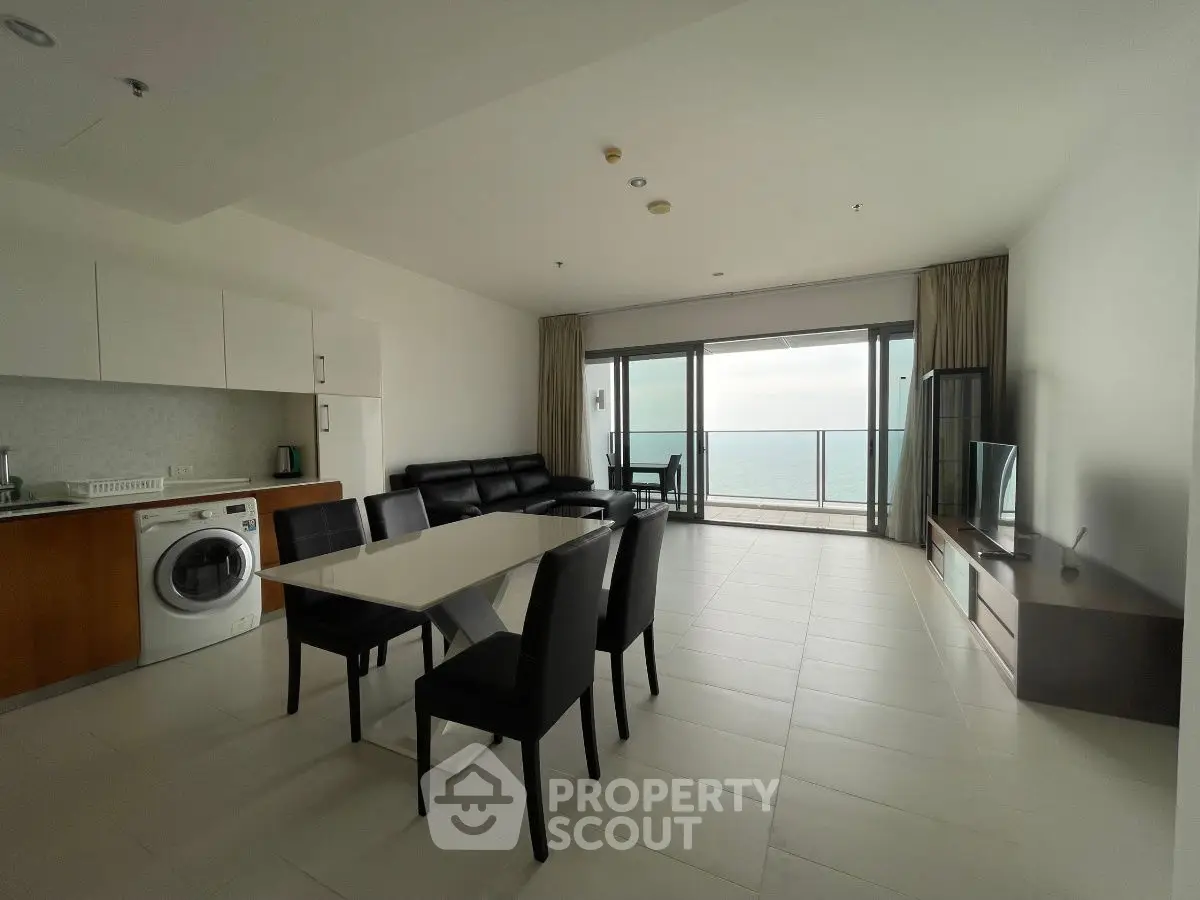 Spacious modern living room with ocean view and open kitchen layout