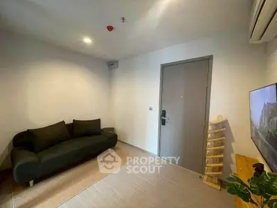 Cozy living room with modern sofa and TV, ideal for relaxation.