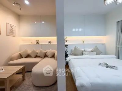 Modern studio apartment with cozy living area and comfortable bed, perfect for urban living.
