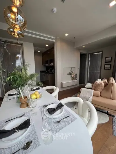 Elegant modern living room with dining area, stylish decor, and open kitchen layout in a luxurious apartment.
