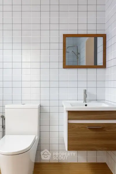 Modern bathroom with sleek fixtures and white tiled walls