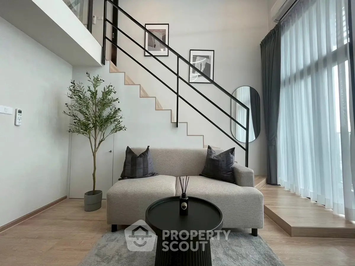 Modern living room with stylish staircase and cozy seating area
