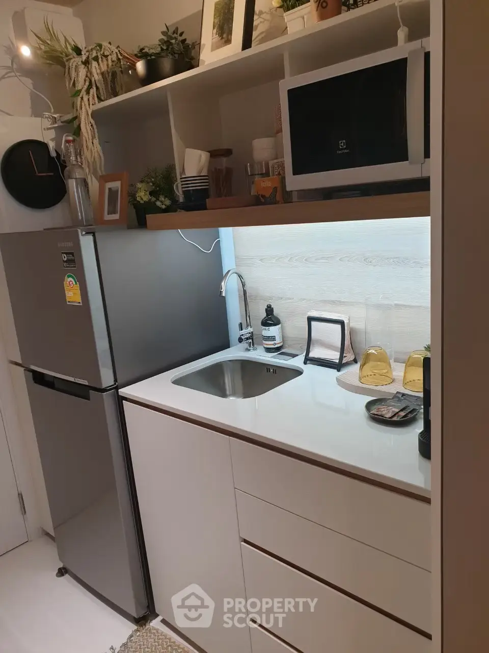 Modern compact kitchen with sleek appliances and stylish decor