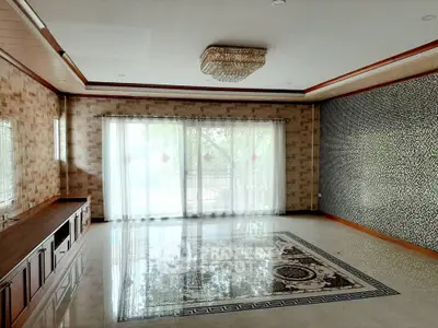 Spacious living room with elegant chandelier and large windows