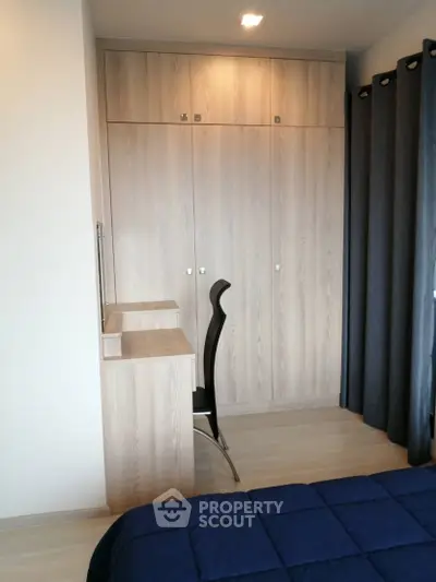 Modern bedroom with built-in wardrobe and sleek desk setup