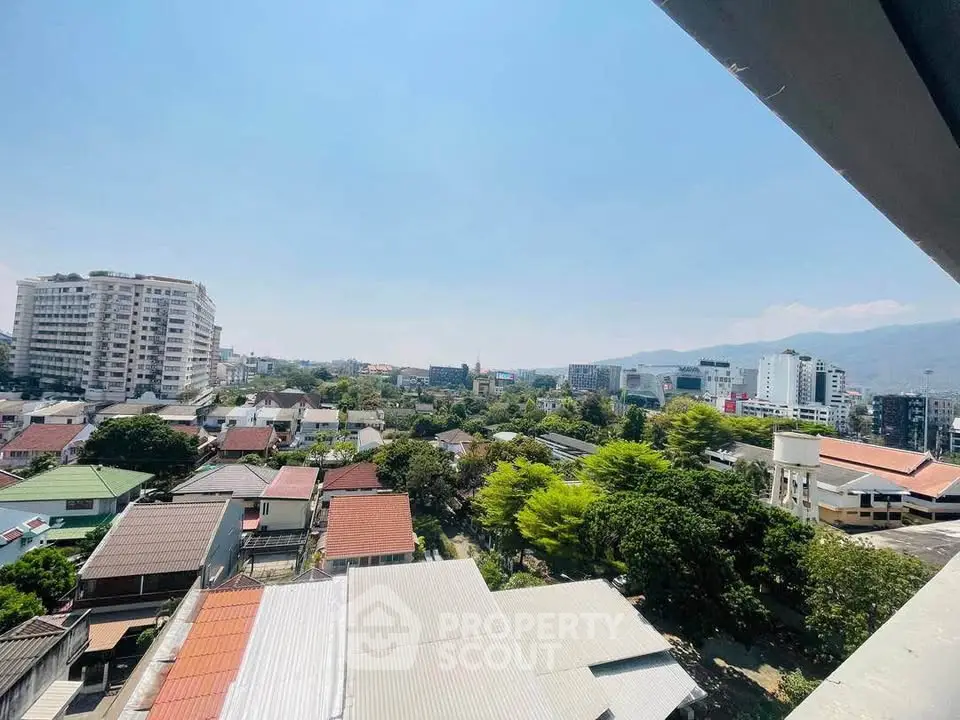 Stunning cityscape view from a high-rise building showcasing urban and natural landscapes.