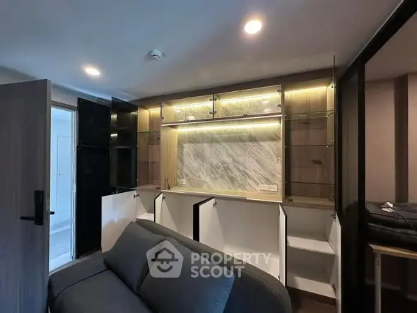 Modern living room with stylish built-in cabinets and cozy sofa