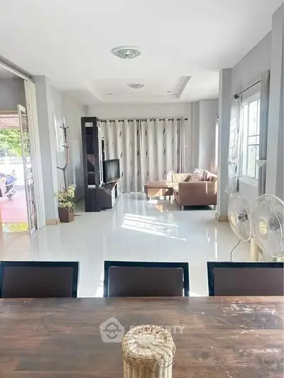 Spacious living room with natural light and modern decor