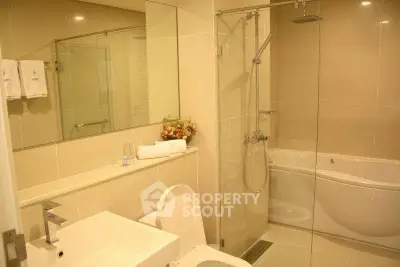 Luxurious bathroom with modern fixtures and elegant bathtub in a stylish real estate property.