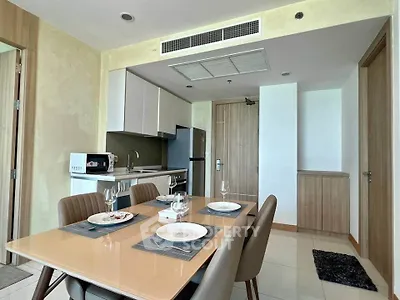 Modern kitchen with dining area featuring sleek cabinetry and contemporary appliances.