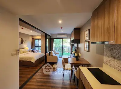 Modern open-plan living room and bedroom with stylish decor and wooden flooring