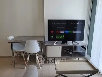 Modern living room with sleek TV setup and stylish furniture, perfect for urban living.
