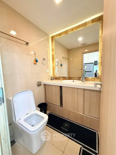 Modern bathroom with elegant fixtures and large mirror in a stylish apartment.
