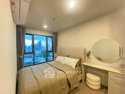 Cozy bedroom with city view, modern decor, and natural light