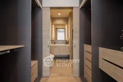 Modern bathroom with sleek wooden cabinetry and elegant lighting