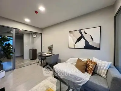 Modern living room with stylish decor and cozy seating area in a contemporary apartment.