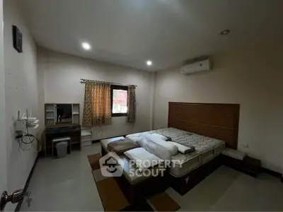 Spacious bedroom with modern furnishings and air conditioning