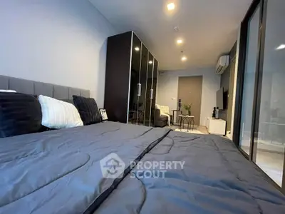 Modern bedroom with sleek design, featuring a cozy bed, stylish wardrobe, and elegant decor.