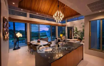 Luxurious open-plan living room with stunning mountain views and elegant chandelier lighting.