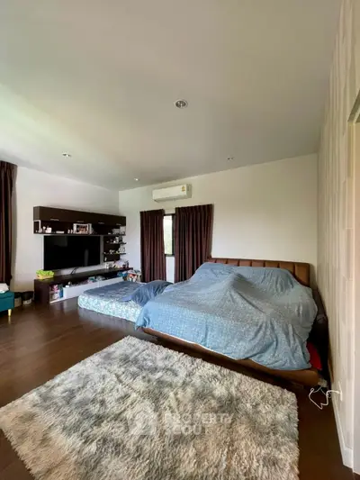 Spacious bedroom with modern decor and cozy ambiance