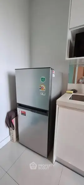 Modern kitchen with sleek stainless steel refrigerator and minimalist design.