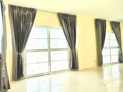 Bright living room with large windows and elegant curtains, perfect for natural light lovers.