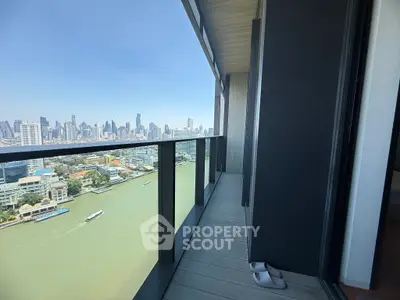 Stunning high-rise balcony with panoramic city and river views, perfect for urban living.