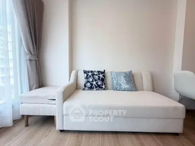 Modern living room with stylish sofa and natural light from large window