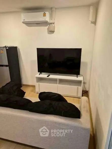 Cozy living room with modern TV setup and air conditioning