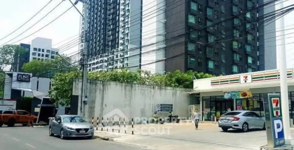 Modern urban street view with high-rise buildings and convenience store