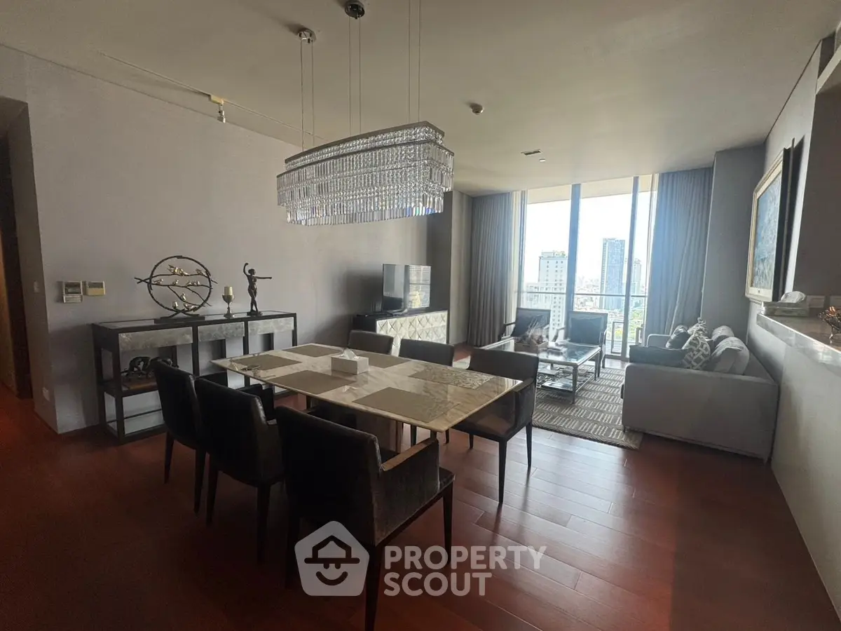 Luxurious living room with elegant chandelier and city view, perfect for modern urban living.