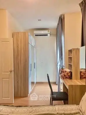 Cozy bedroom with wooden furniture and air conditioning, perfect for relaxation.