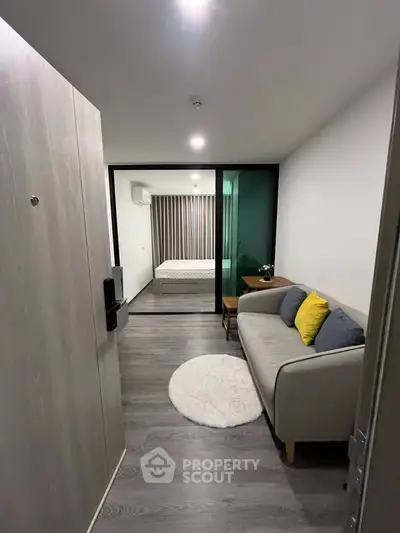 Modern apartment interior with cozy living room and bedroom, featuring stylish decor and open layout.