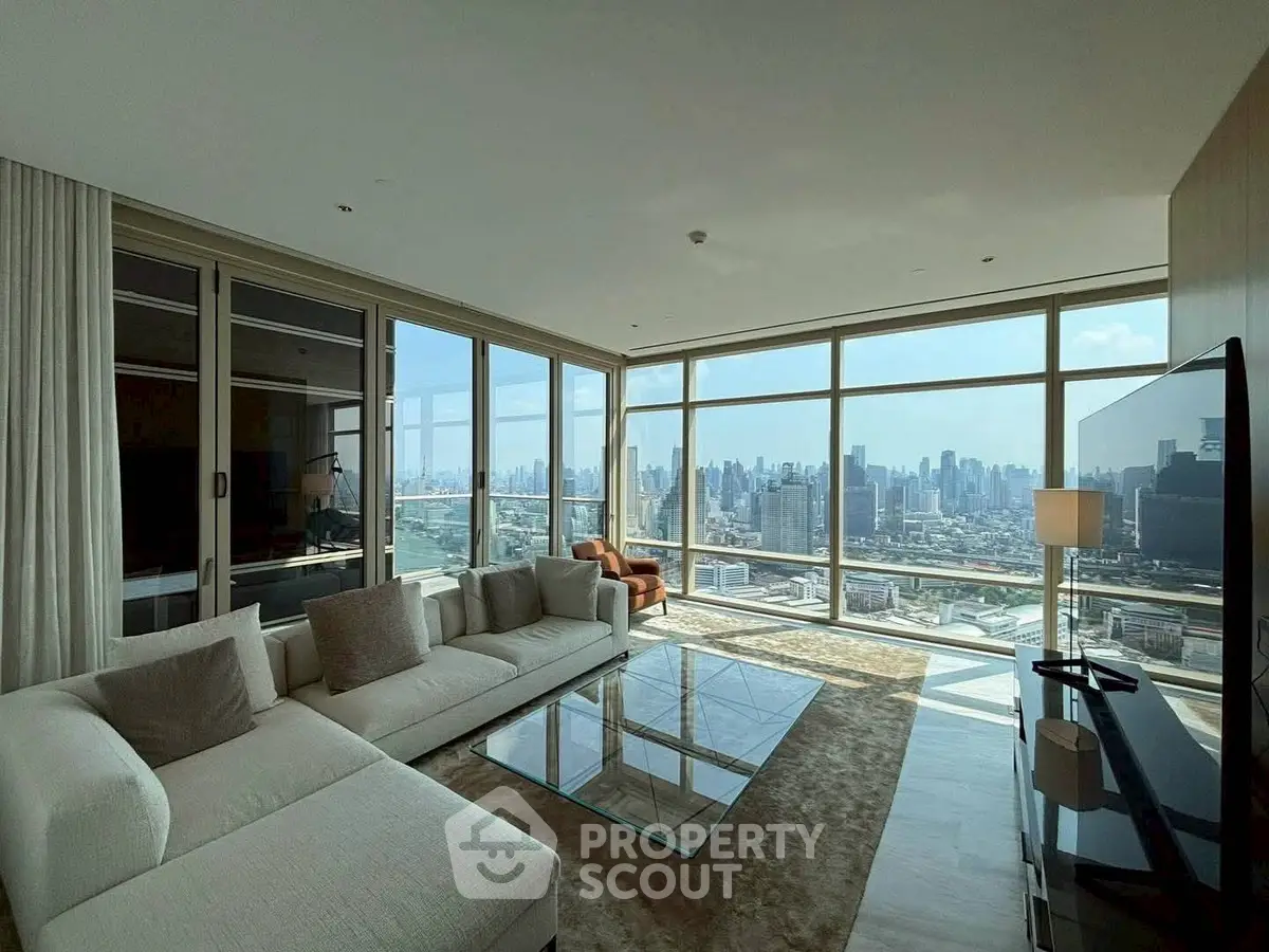 Luxurious living room with panoramic city skyline view and modern furnishings.
