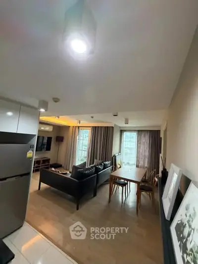 Modern living room with open layout and stylish furniture in a high-rise apartment.